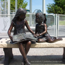 Statue de lecture de fille de bronze